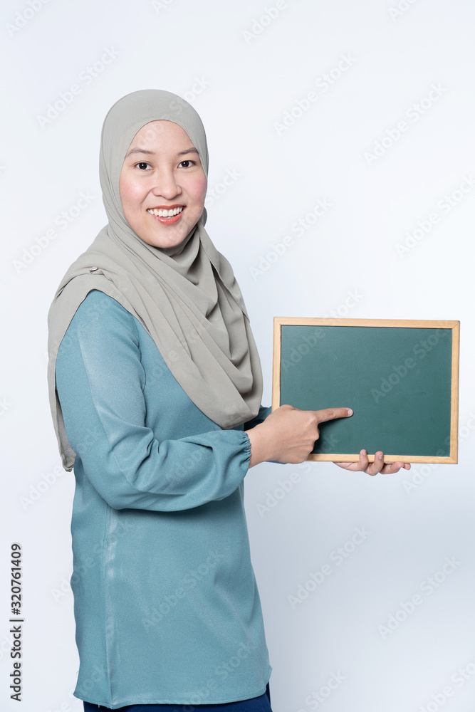 Female muslim woman holding a chalk board. Female muslim woman holding a chalk board.