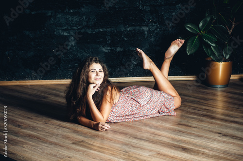 Bilde på lerret beautiful girl with magnificent hair in a summer sundress in the studio