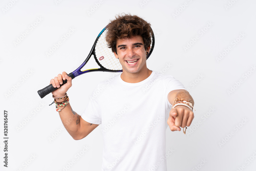 Young caucasian man over isolated white background playing tennis and pointing to the front Young caucasian man over isolated white background playing tennis and pointing to the front