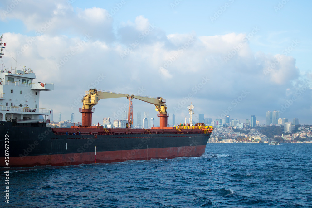 The big cargo ship passing through the Bosphorus. The back was photographed from the right. It has black and broad color.