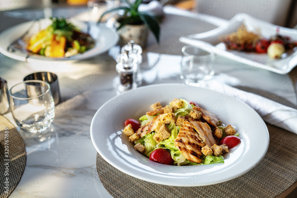 A delicious grilled or roasted chicken salad is served in a elegance restaurant or hotel.