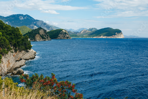 view of the sea bay and lots of green trees around photo