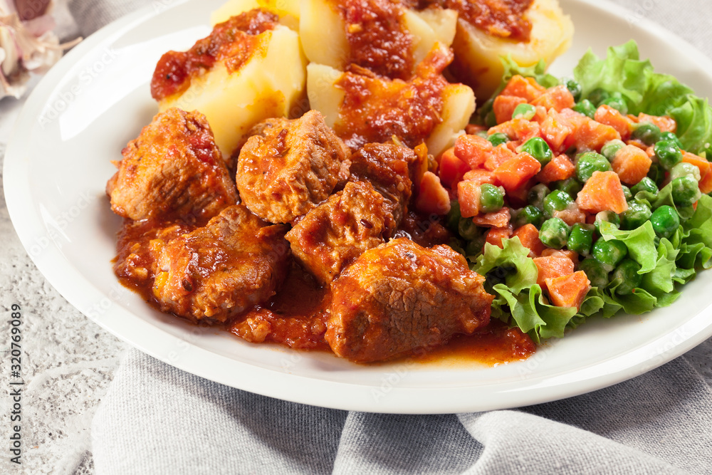 Braised pork meat stew served with potatoes Braised pork meat stew served with potatoes