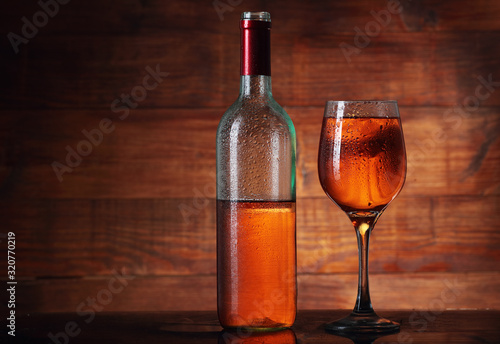 incomplete bottle with wine and goblet