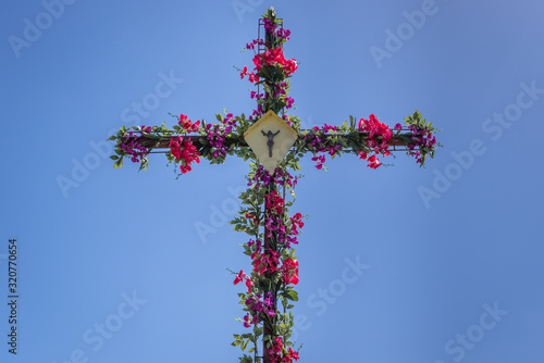 Wayside cross decorated with plastic flowers in Wicimice, small village located in West Pomerania region of Poland photo