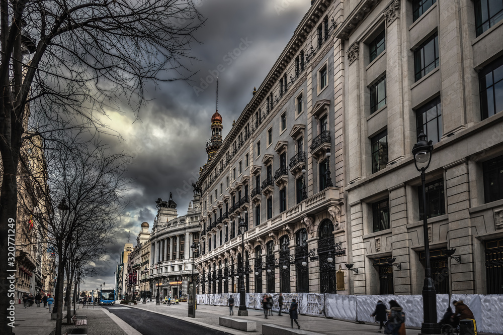Luxury buildings in downtown Madrid under a dramatic sky