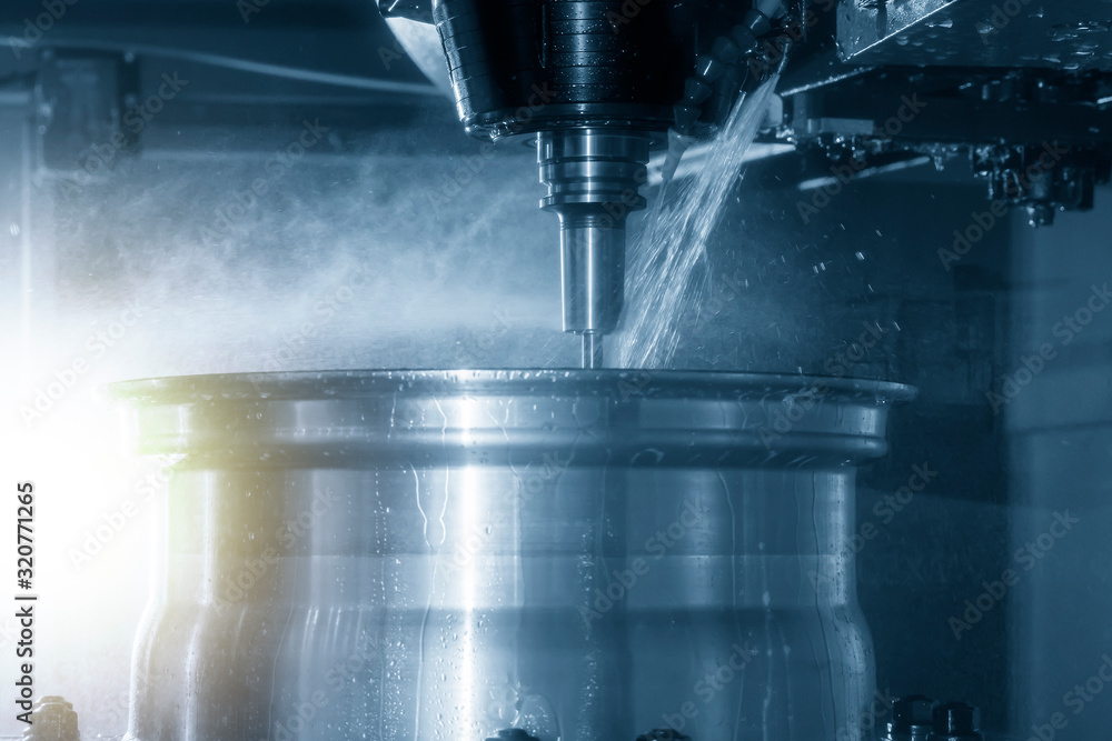 The 5-axis CNC milling machine cutting magnesium alloy wheel by solid ball endmill tool with liquid coolant method. The automotive parts manufacturing process by CNC machining center. The 5-axis CNC milling machine cutting magnesium alloy wheel by solid ball endmill tool with liquid coolant method. The automotive parts manufacturing process by CNC machining center.