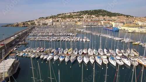 Sète harbor drone shot with nice sailboats. Drone moving forward in Mont Saint Clair's direction. photo