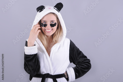  Portrait of woman with patches in panda bathrobe.
