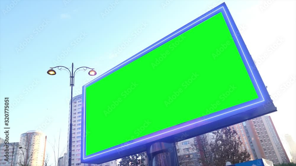 Green screen billboard on urban, city life. Blank advertisement panel ...