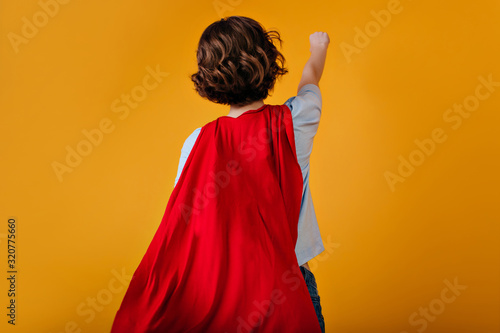 Fototapeta Portrait from back of supergirl with short hairstyle