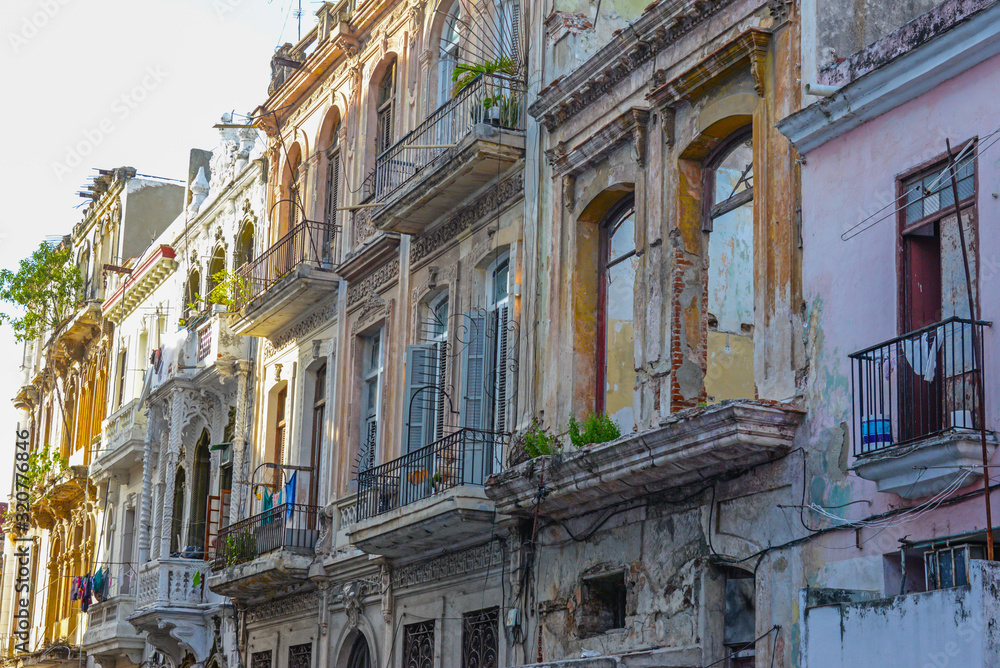 Old facade of houses with balconies on the street in Havana, Cuba