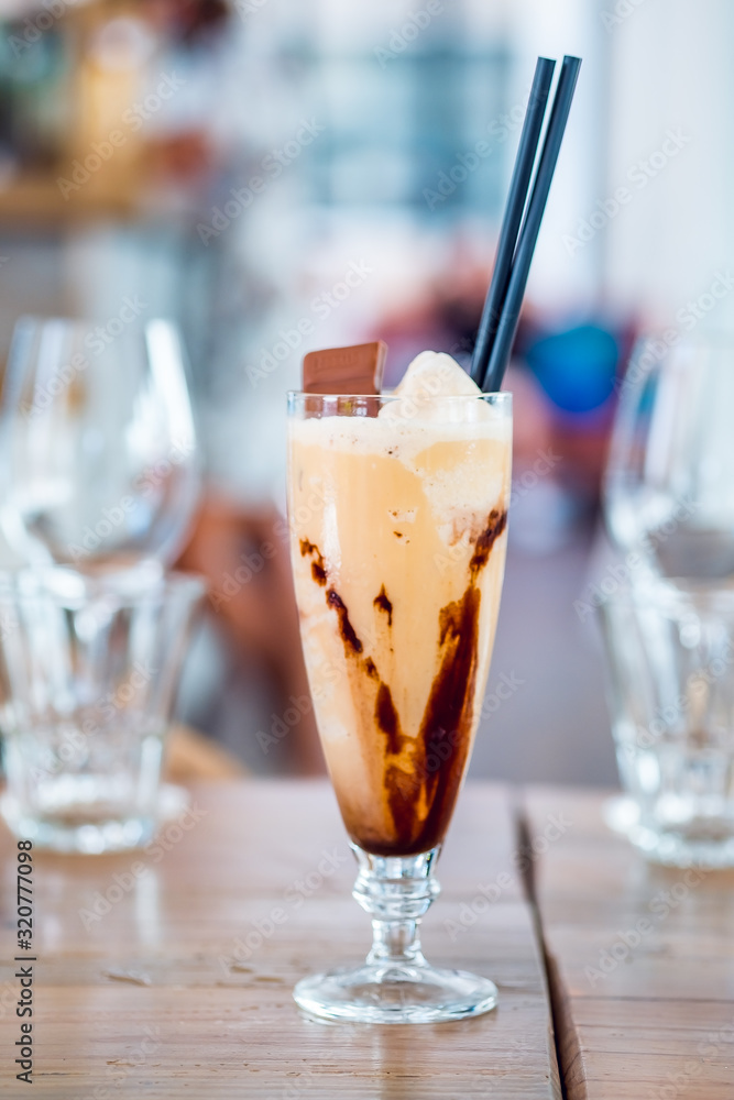 Glass of chocolate milkshake with tasty whipped cream and piece of chocolate. Glass of chocolate milkshake with tasty whipped cream and piece of chocolate.