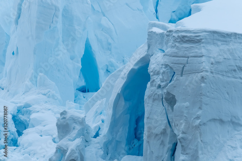 Glacier wall, Paradise Harbor, also known as Paradise Bay, behind Lemaire and Bryde Islands in Antarctica.