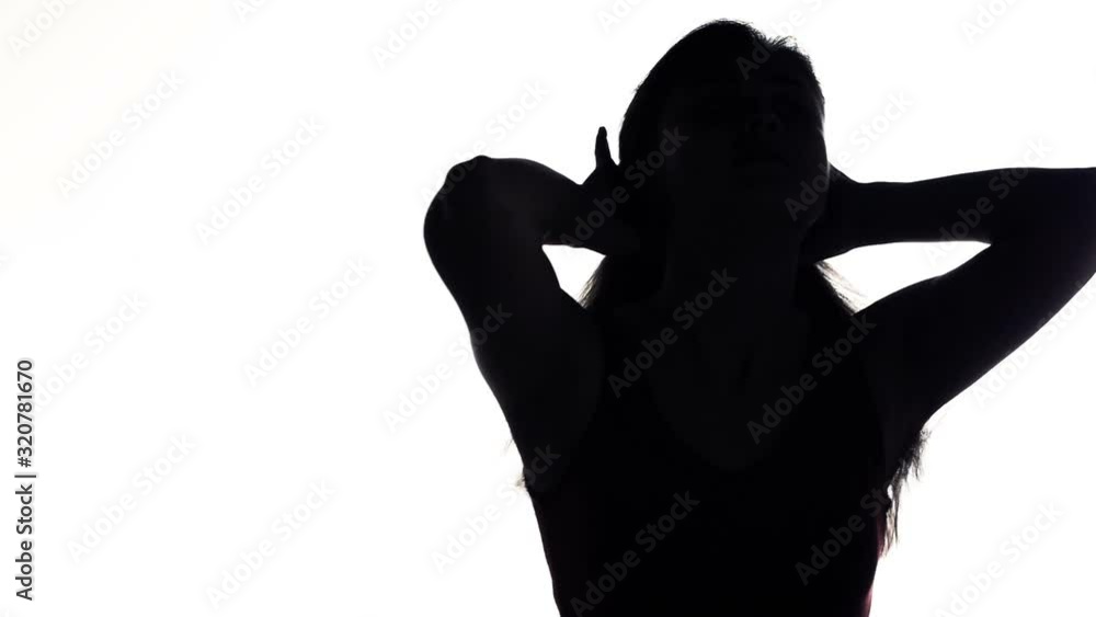 silhouette of a young woman doing ponytail hairstyle on white isolated background, concept lifestyle and female beauty silhouette of a young woman doing ponytail hairstyle on white isolated background, concept lifestyle and female beauty
