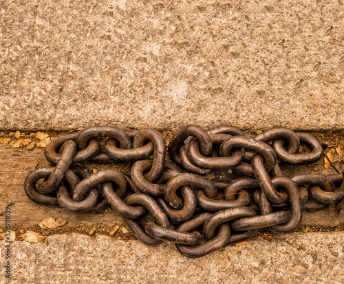 Old wooden column with thick chains photo