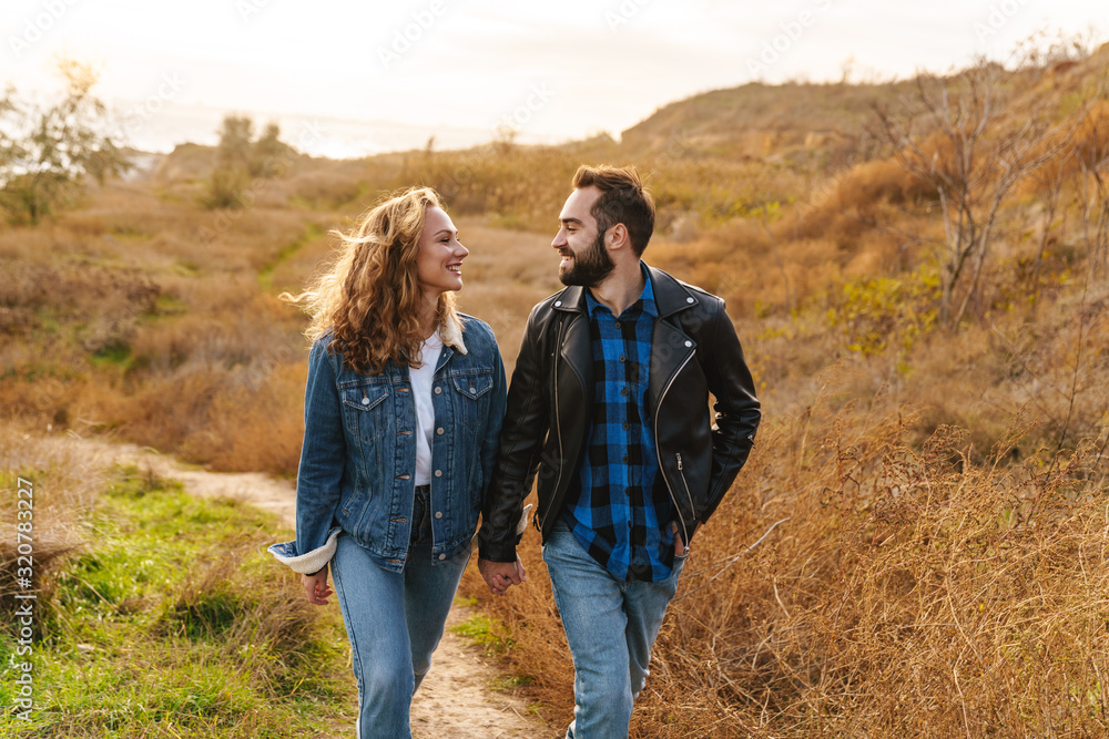 Image of beautiful couple dating and walking together in countryside Image of beautiful couple dating and walking together in countryside