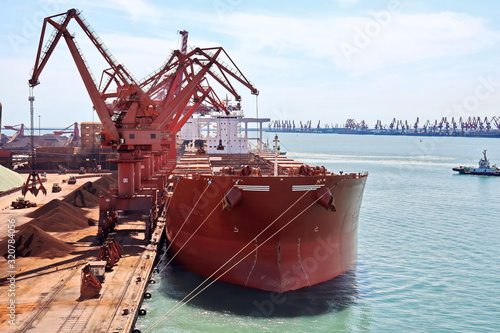 Type of cargo terminal and cranes, berths for transshipment of bulk cargo iron ore. Port Rizhao, China.