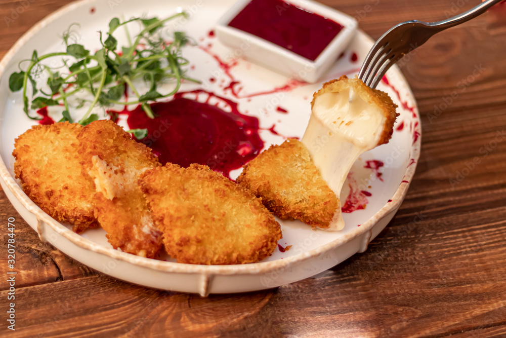 Camembert cheese fried in batter and breadcrumbs with cranberry sauce