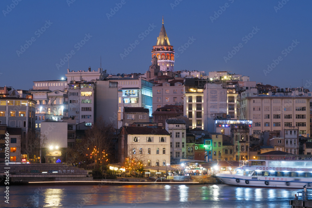 Istanbul, Turkey - Jan 10, 2020: Ferry boat in Golden Horn with Galata Tower in background, Istanbul, Turkey, Europe