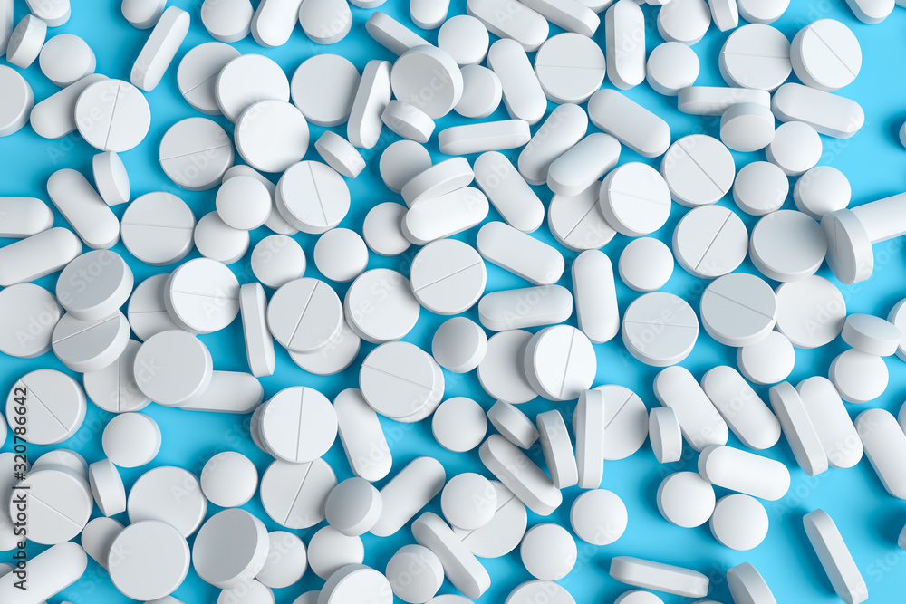 Bunch of different whitel pills at the blue table. Pharmaceutical industry and health care concept. Top view. Bunch of different whitel pills at the blue table. Pharmaceutical industry and health care concept. Top view.