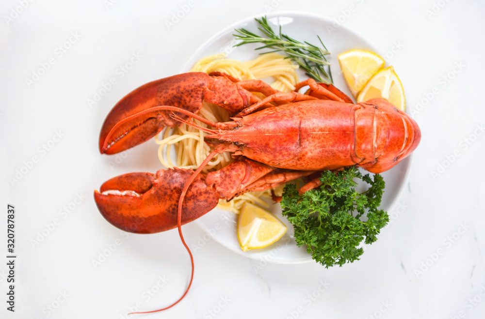 Fresh lobster food on a white plate background - red lobster dinner seafood with herb spices lemon rosemary served table in the restaurant gourmet food healthy boiled lobster cooked salad Fresh lobster food on a white plate background - red lobster dinner seafood with herb spices lemon rosemary served table in the restaurant gourmet food healthy boiled lobster cooked salad