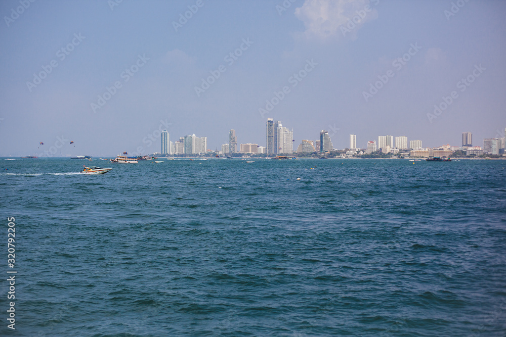 Fototapeta premium Boat in sea on background of island. Blue water, paradise relaxation. Place under the text, advertising tours. Sea travel