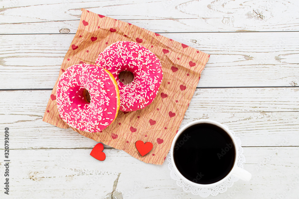 Valentine's day romantic breakfast. Gift, hearts and donuts. Valentines day concept. Copy space