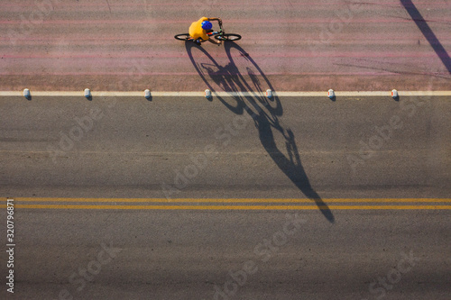 Mountain biker ride in a cycle lane in the highway . Photo shot by drone.