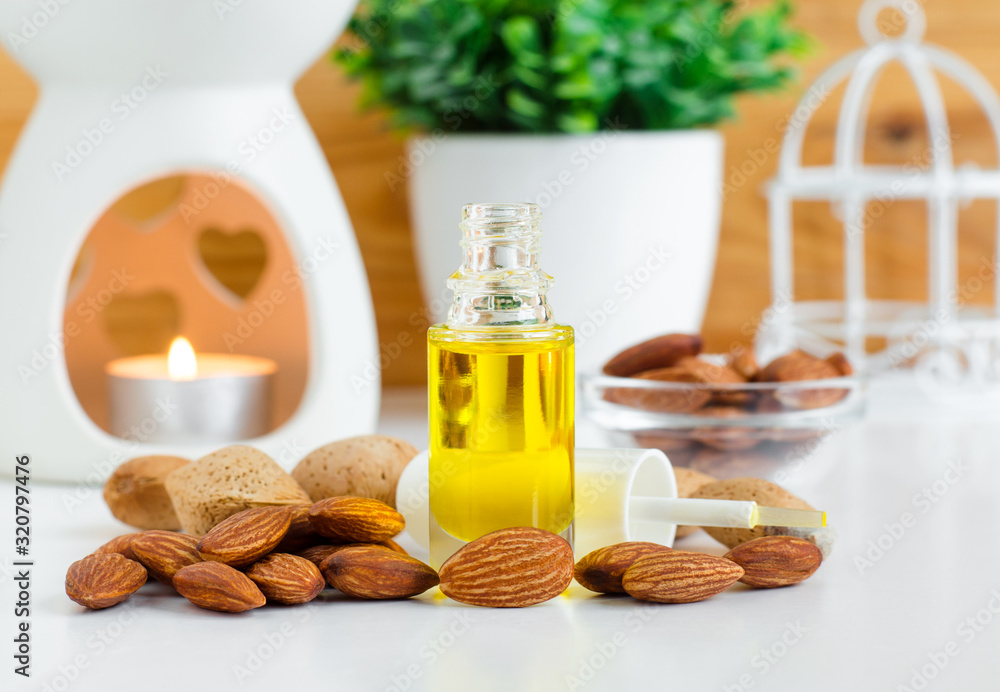 Small glass bottle with almond oil for natural nails and cuticle care. Healthy manicure and pedicure concept. Copy space. Small glass bottle with almond oil for natural nails and cuticle care. Healthy manicure and pedicure concept. Copy space.