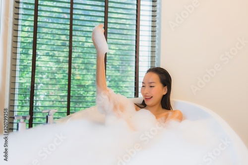 Portrait beautiful young asian woman happy smile relax take a bath in bathtub