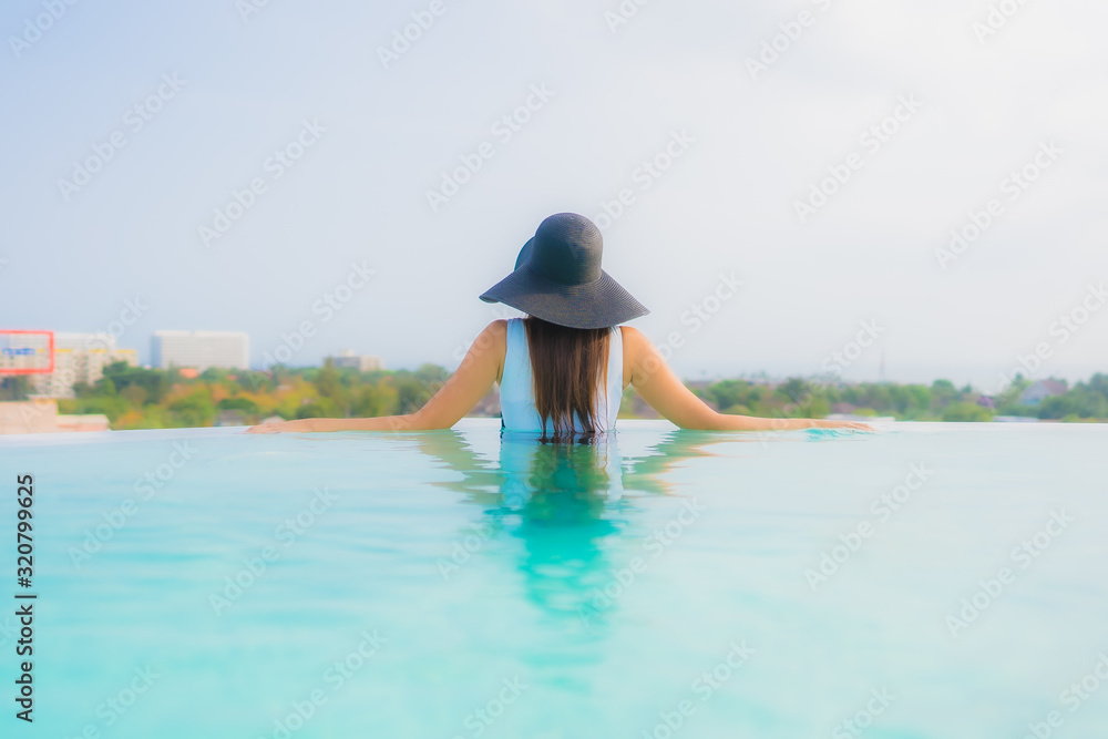 Portrait beautiful young asian woman happy smile relax around outdoor swimming pool in hotel resort Portrait beautiful young asian woman happy smile relax around outdoor swimming pool in hotel resort