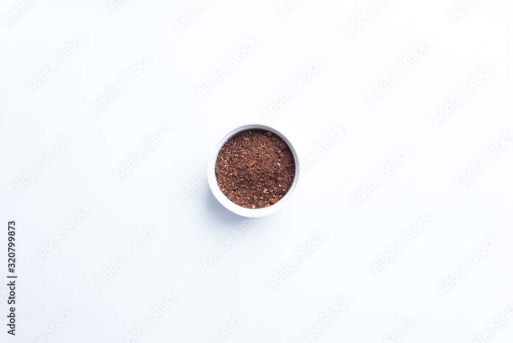 Ground pomegranate seeds spice close up in bowl on white background Ground pomegranate seeds spice close up in bowl on white background