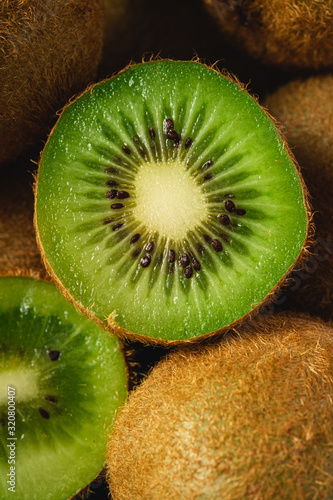 Kiwi fruit half sliced close up macro, healthy lifestyle and food, vibrant green color