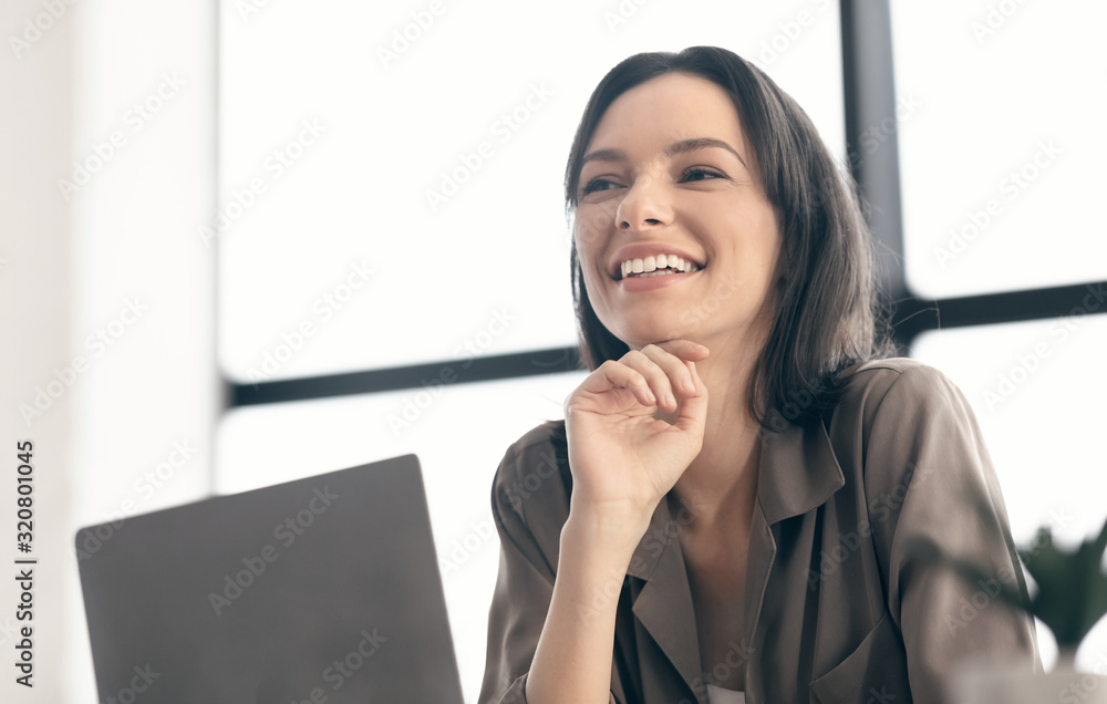 Portrait of happy woman looking aside at office Portrait of happy woman looking aside at office
