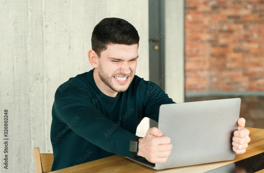 Mad Office Guy Breaking Laptop Sitting At Workplace Indoor Mad Office Guy Breaking Laptop Sitting At Workplace Indoor