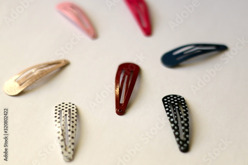Fashionable colorful hair clips on white background. Selective focus.