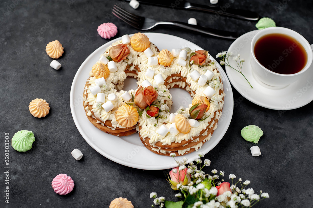 tea and cake in the form of 8 is decorated with flowers, cream cheese, marshmallows, Bizet on a stone background. romantic delicious breakfast on International Women's Day March 8 tea and cake in the form of 8 is decorated with flowers, cream cheese, marshmallows, Bizet on a stone background. romantic delicious breakfast on International Women's Day March 8