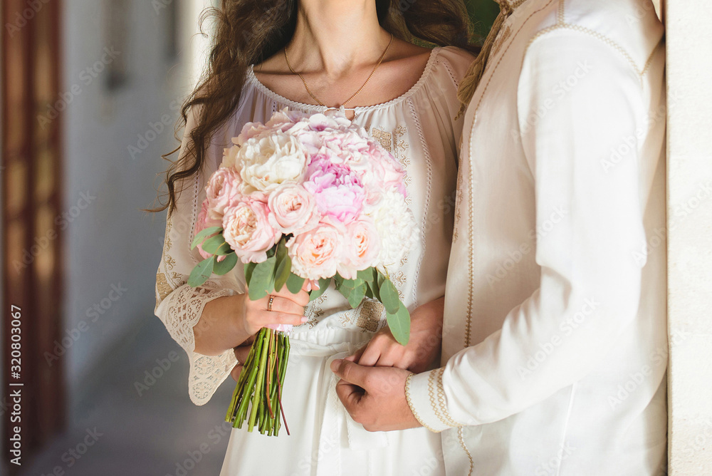 groom hugging bride with bouquet groom hugging bride with bouquet