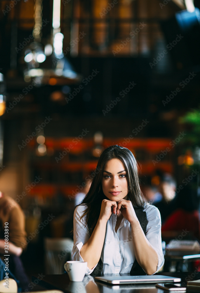 Portrait of smiling attractive woman looking at camera cafe. Portrait of smiling attractive woman looking at camera cafe.