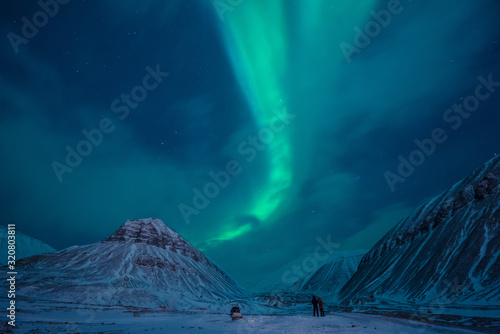 The polar arctic Northern lights aurora borealis sky star in Norway Svalbard in Longyearbyen with the mountains. Travel adventure