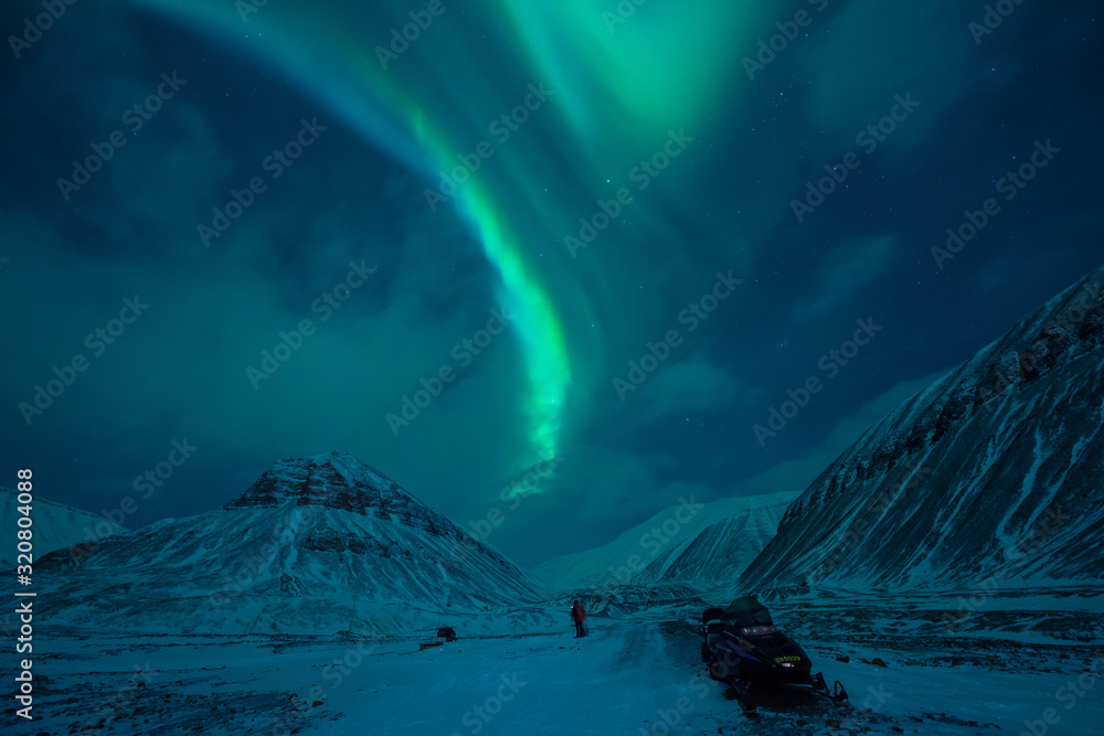 The polar arctic Northern lights aurora borealis sky star in Norway Svalbard in Longyearbyen  with the  mountains. Travel adventure