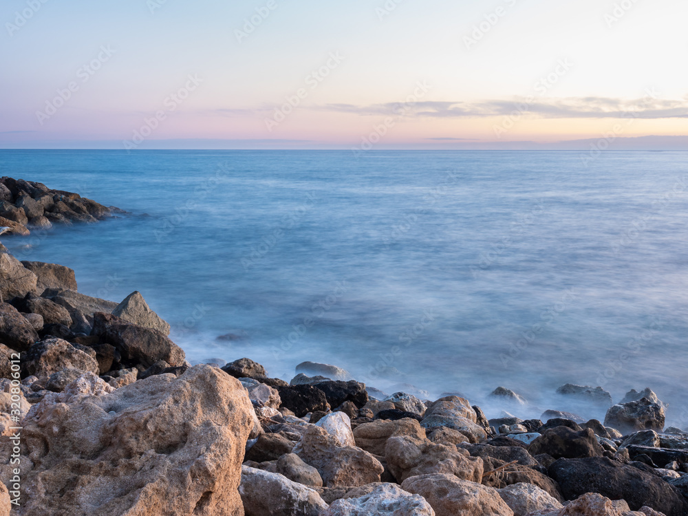 Evening time long exposure photo of waves crashing on rocks in Paphos, Cyprus, Evening time long exposure photo of waves crashing on rocks in Paphos, Cyprus,