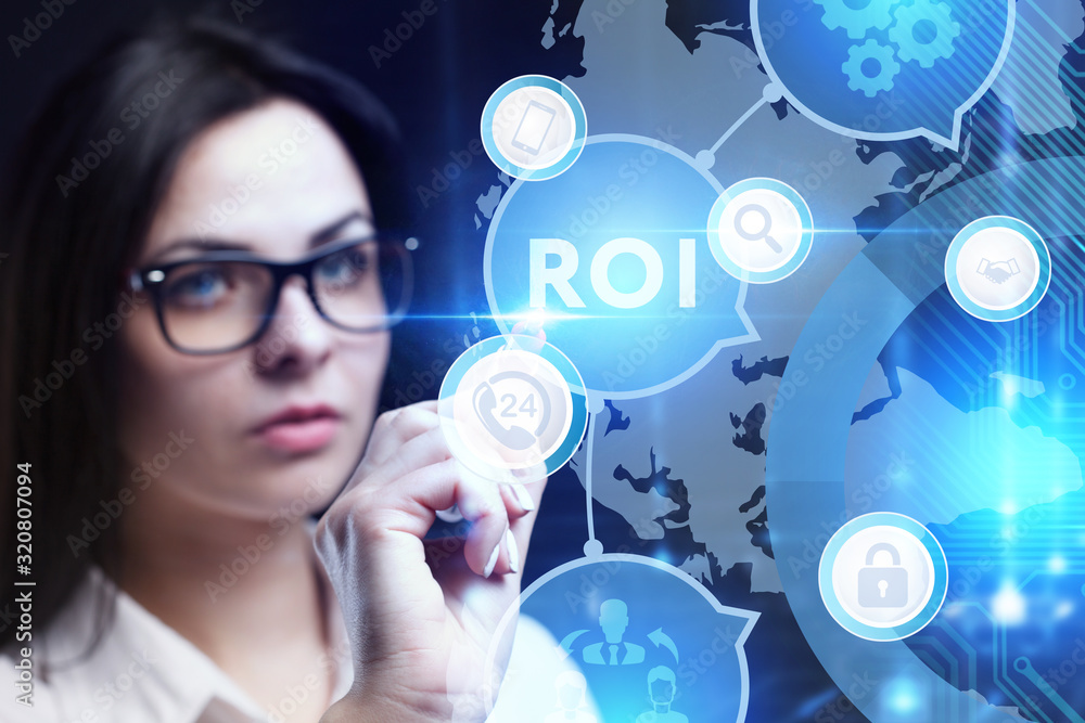 Business, Technology, Internet and network concept. Young businessman working on a virtual screen of the future and sees the inscription: ROI Business, Technology, Internet and network concept. Young businessman working on a virtual screen of the future and sees the inscription: ROI