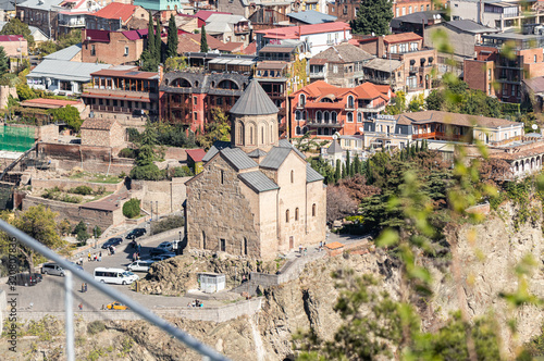 View from the Narikhala Hill to the Metekhi St. Virgin Church in old part of Tbilisi city in Georgia photo