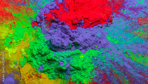 Holi color powder. Organic Gulal colours in bowl for Holi festival, Hindu tradition festive. Bright vibrant pigment closeup