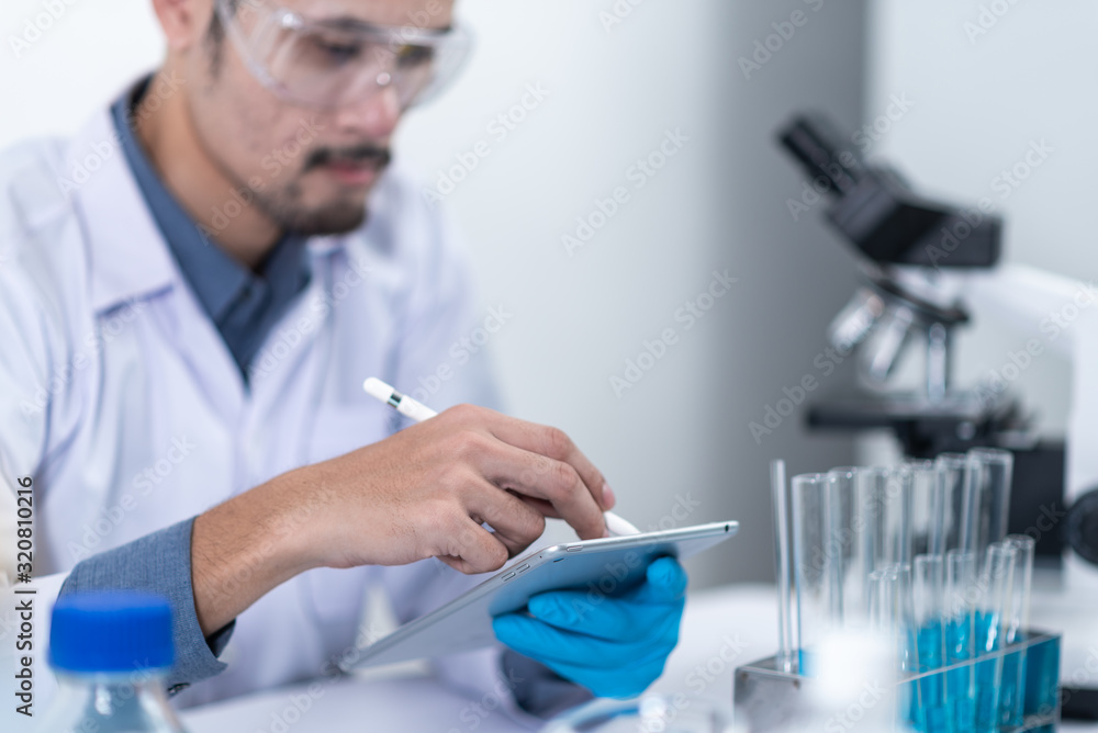 Scientists are working with digital tablet in laboratory Scientists are working with digital tablet in laboratory