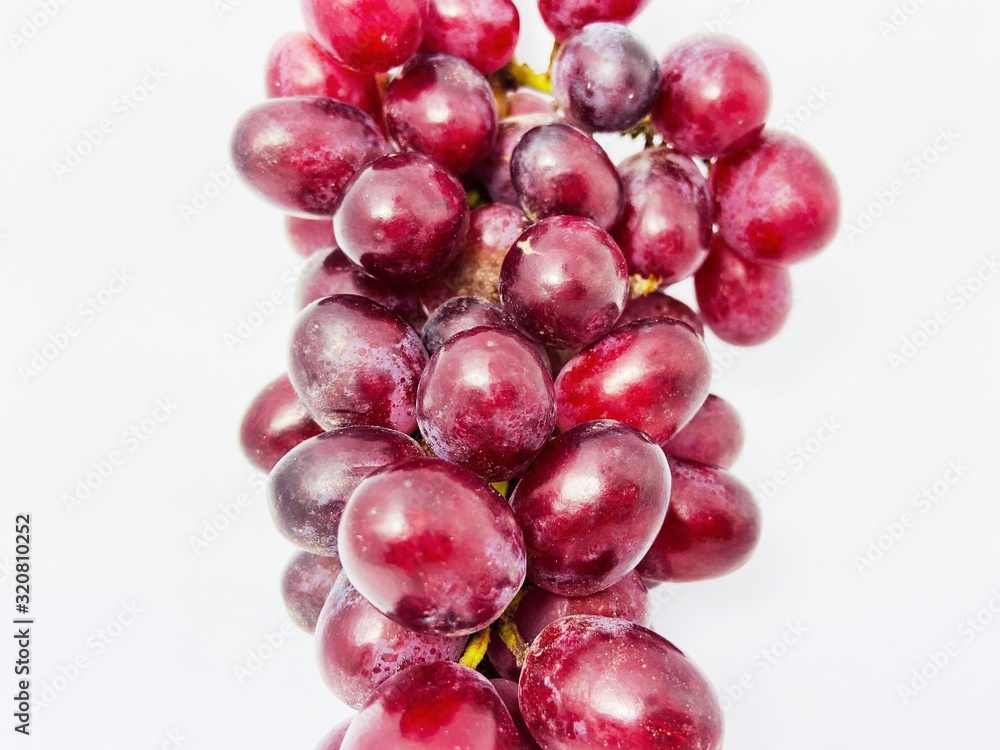 Fototapeta premium bunch of red grapes isolated on white