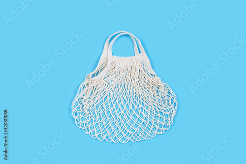 One reusable shopping bag on blue background.