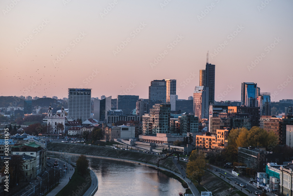 Vilnius modern financial district panorama at dusk from Gediminas tower with Neris river running in between